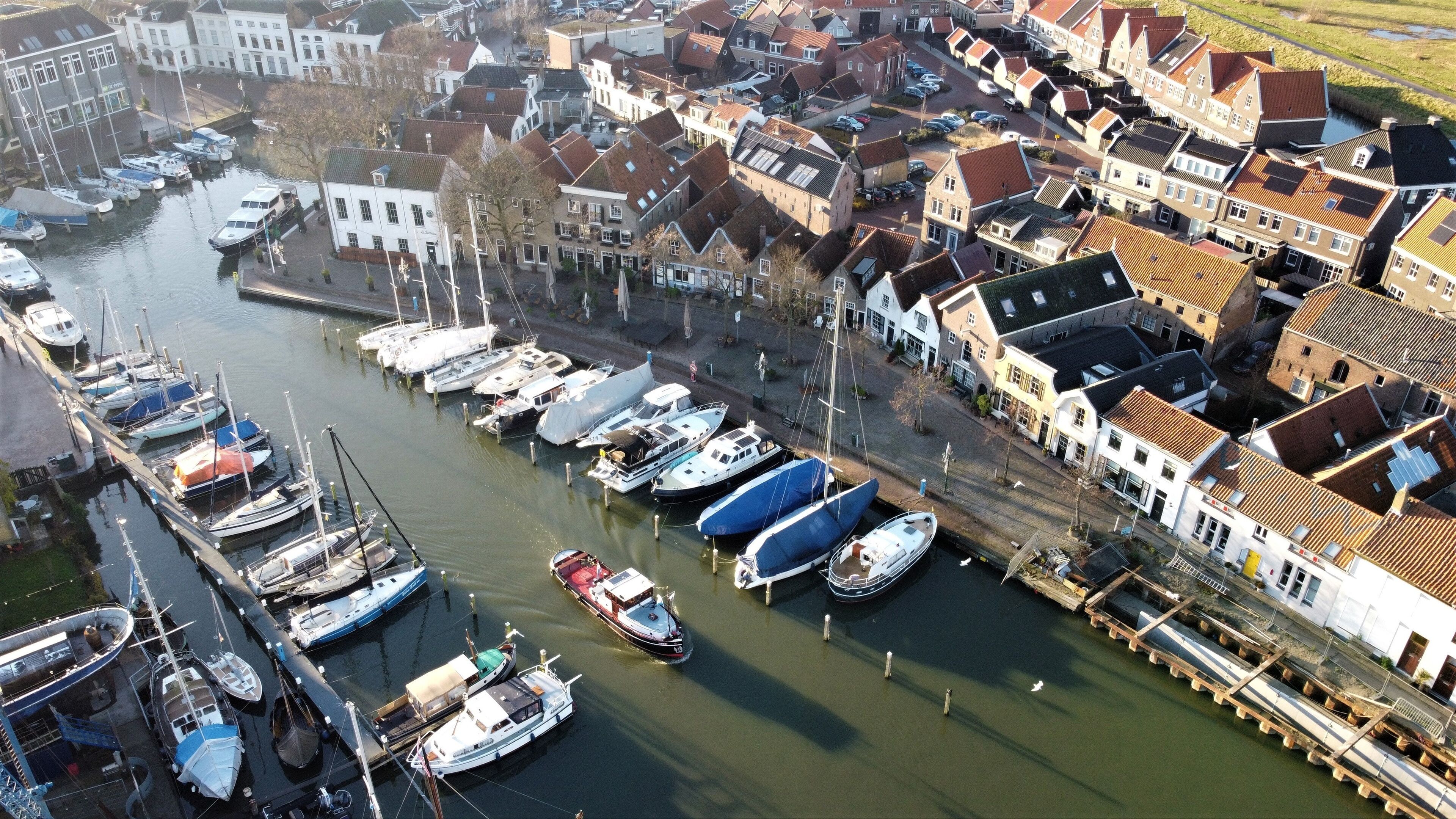 Dutch fishing village Middelharnis on Goeree overflakkee in the Netherlands. The new harbor photographed from the air. Traditional house construction in new neighborhood with traditional architecture.