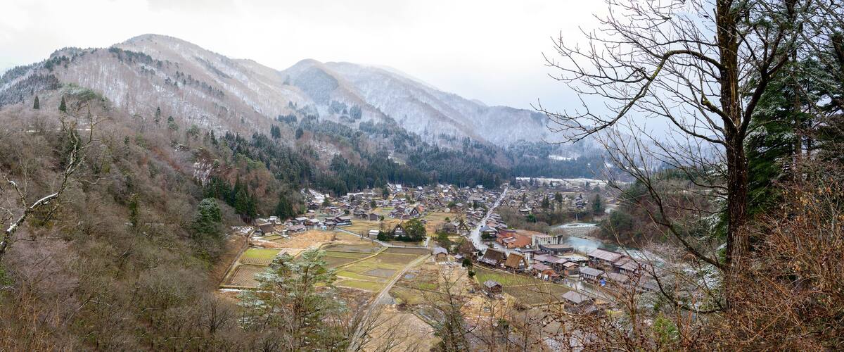 A mountainous landscape with a village nestled in the valley.