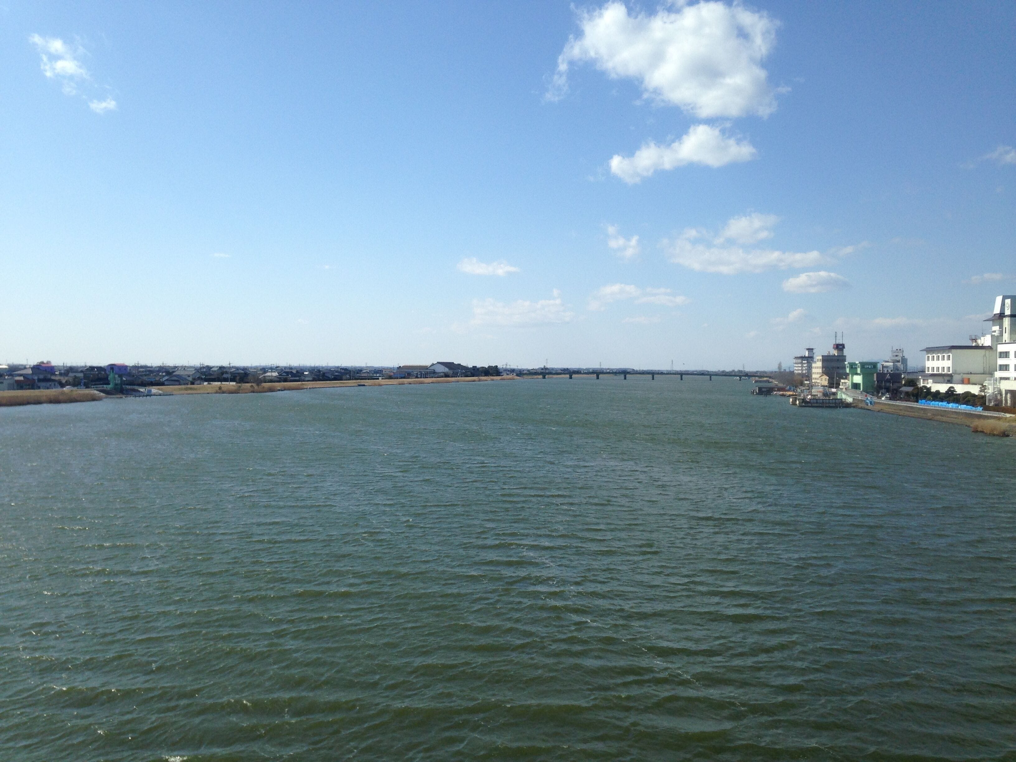 鹿島線列車より望む北利根川(上流側)。右端は潮来市街地、右側の橋は潮来大橋