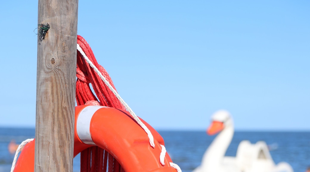life preserver hanging on the pole on the sandy beach to assist lifeguards during drownings at sea