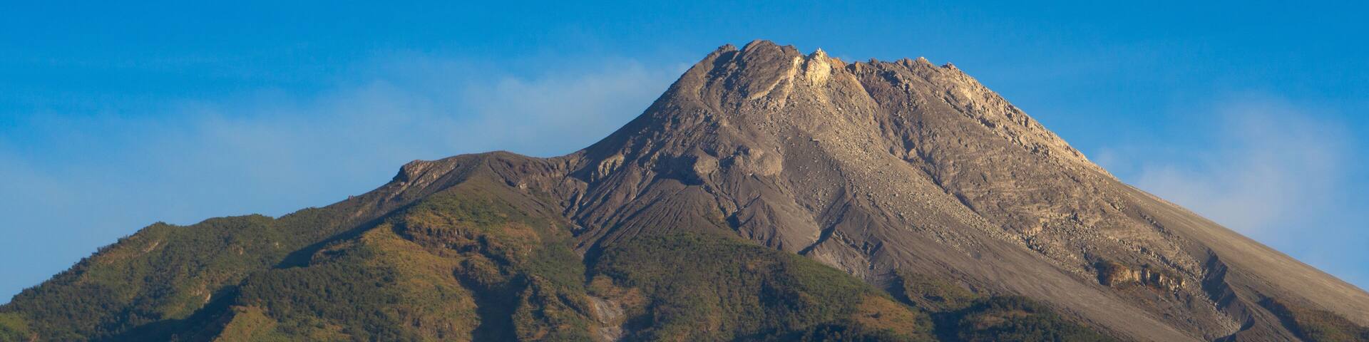 The great Mount Merapi Volcano with clear blue sky in the background viewed from Selo Boyolali, Central Java - Indonesia.