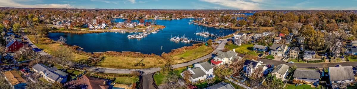 Aerial panorama view of Edgewater Maryland Almshouse Creek South River marina with luxury sail boats turquoise water, popular retirement community near Annapolis