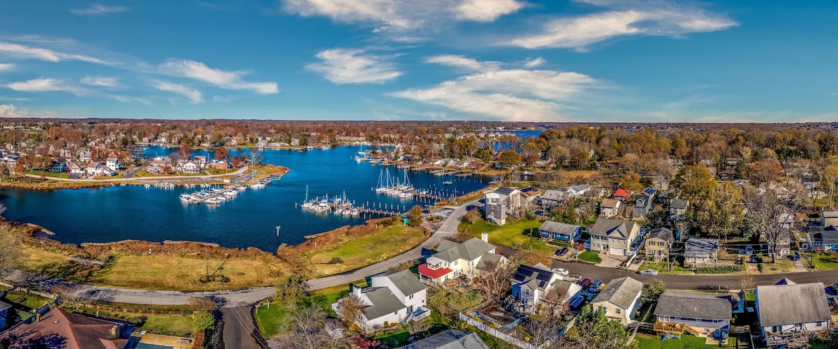 Aerial panorama view of Edgewater Maryland Almshouse Creek South River marina with luxury sail boats turquoise water, popular retirement community near Annapolis