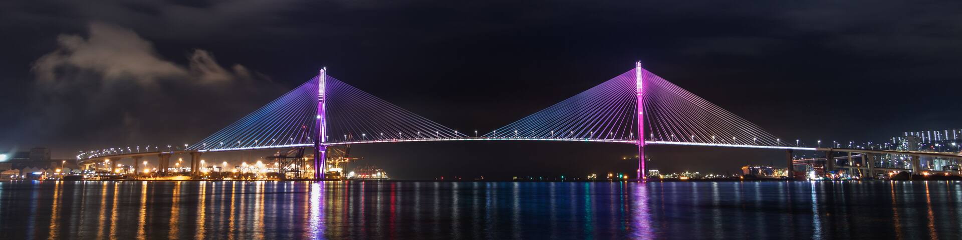 Night view of the Busan Harbor Bridge illuminated, connecting the Yeongdo and Nam districts in Busan, South Korea.
