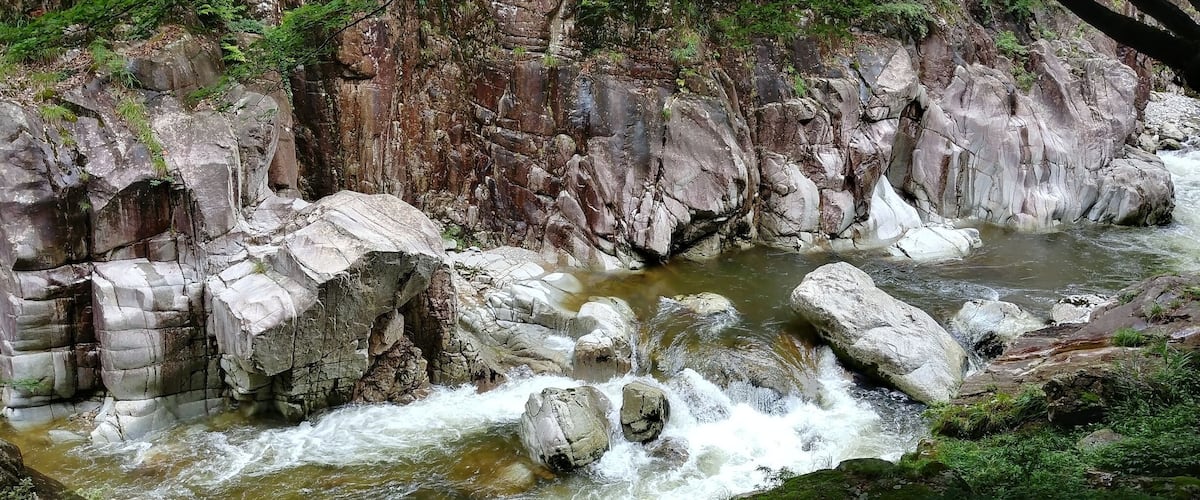 A rocky river with clear water flowing over rocks.