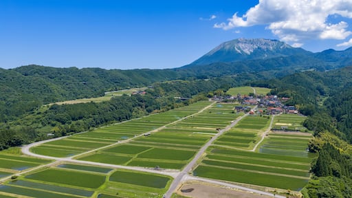 A mountainous landscape with terraced fields and a small village.