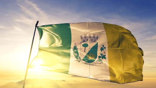 Arapiraca of Brazil flag waving on the top sunrise mist fog