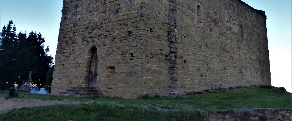 A large stone castle with a tall tower and arched windows.