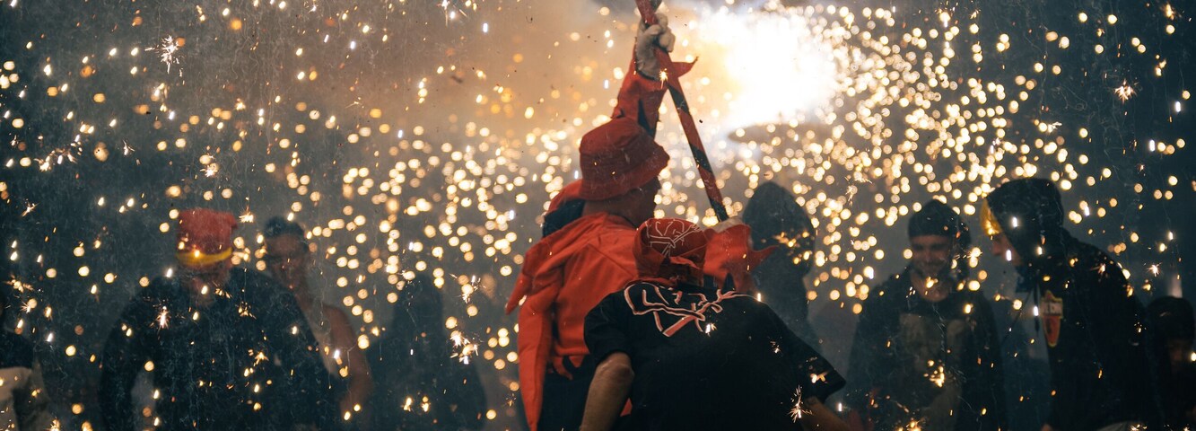 correfoc canovelles, people dancing around devil carrying fireworks in catalonia spain