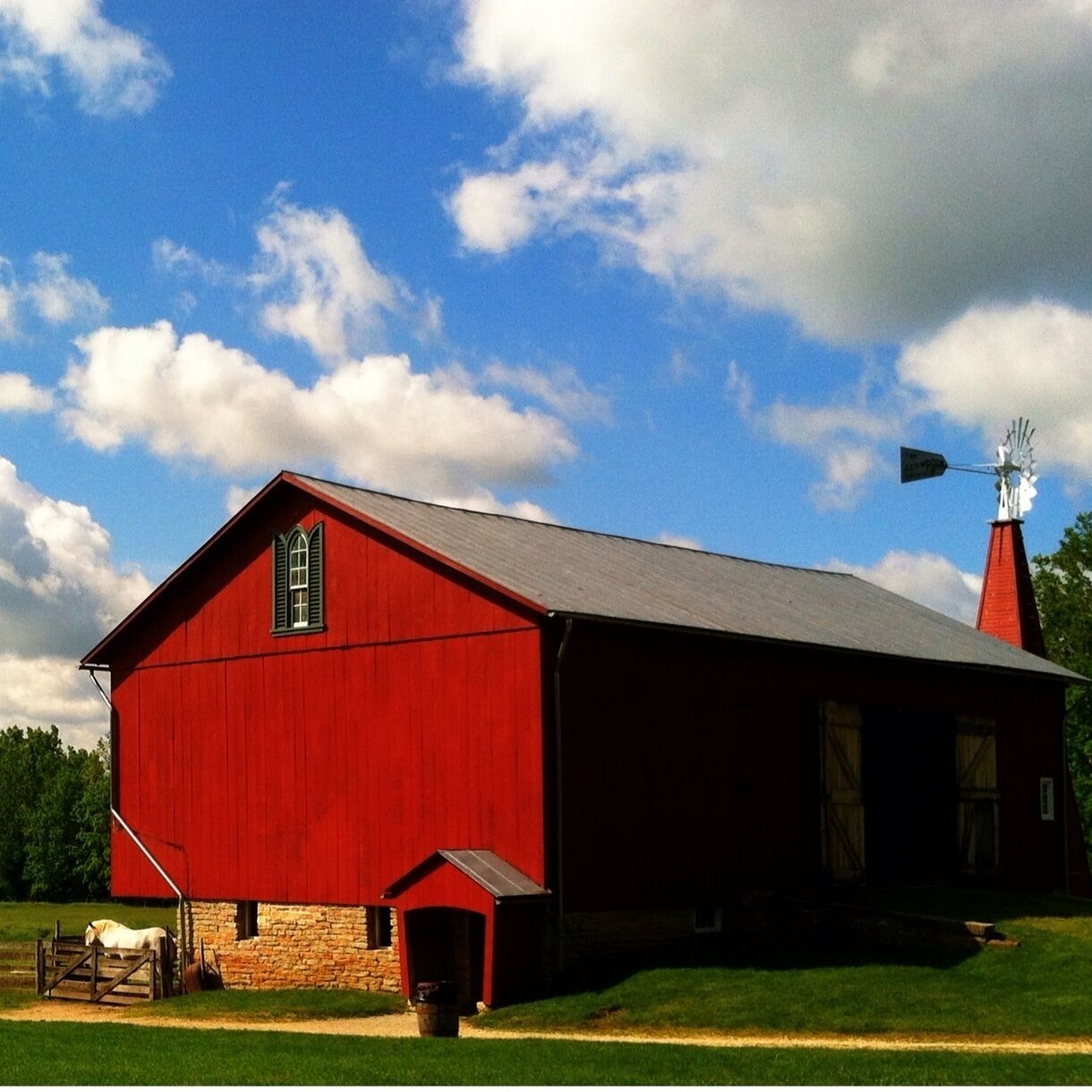 This historical farm, tucked away amid the suburbs of Dayton, Ohio, provides its visitors with a glimpse of what farm life was like just a few short 150 years or so ago...
The bright red barn on the grounds is certainly an eye catcher, and is complete with a windmill, horses, pigs, hens and a rooster... who by the way, is very protective of his hens! 
The history of the farm is told in the visitor center, and a riding center on the farm provides trail rides. 
Overall, a fun family day outing!