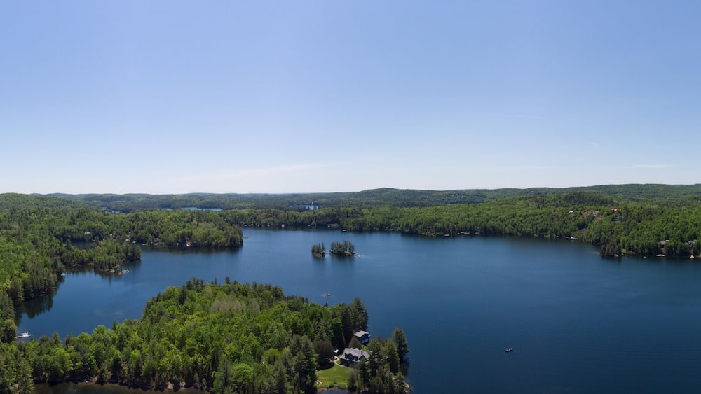 Drone aerial shot over Grand Lake in Val-des-Monts, QC, Canada