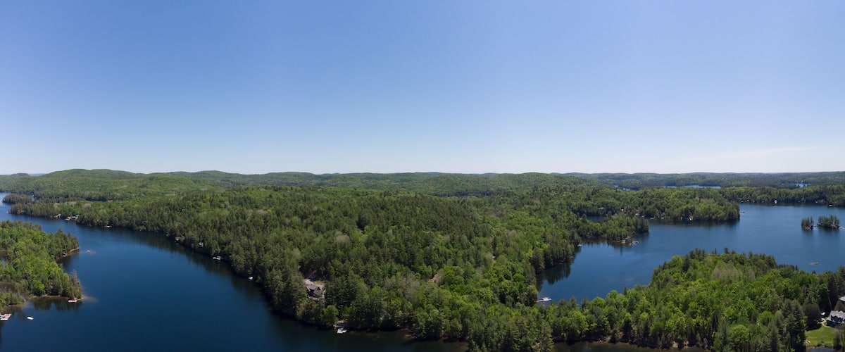 A lake surrounded by dense forest and hills.