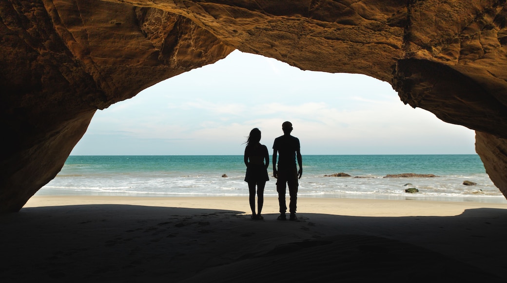Romantic Couple Watching the Ocean from a Cave in Mancora, Peru