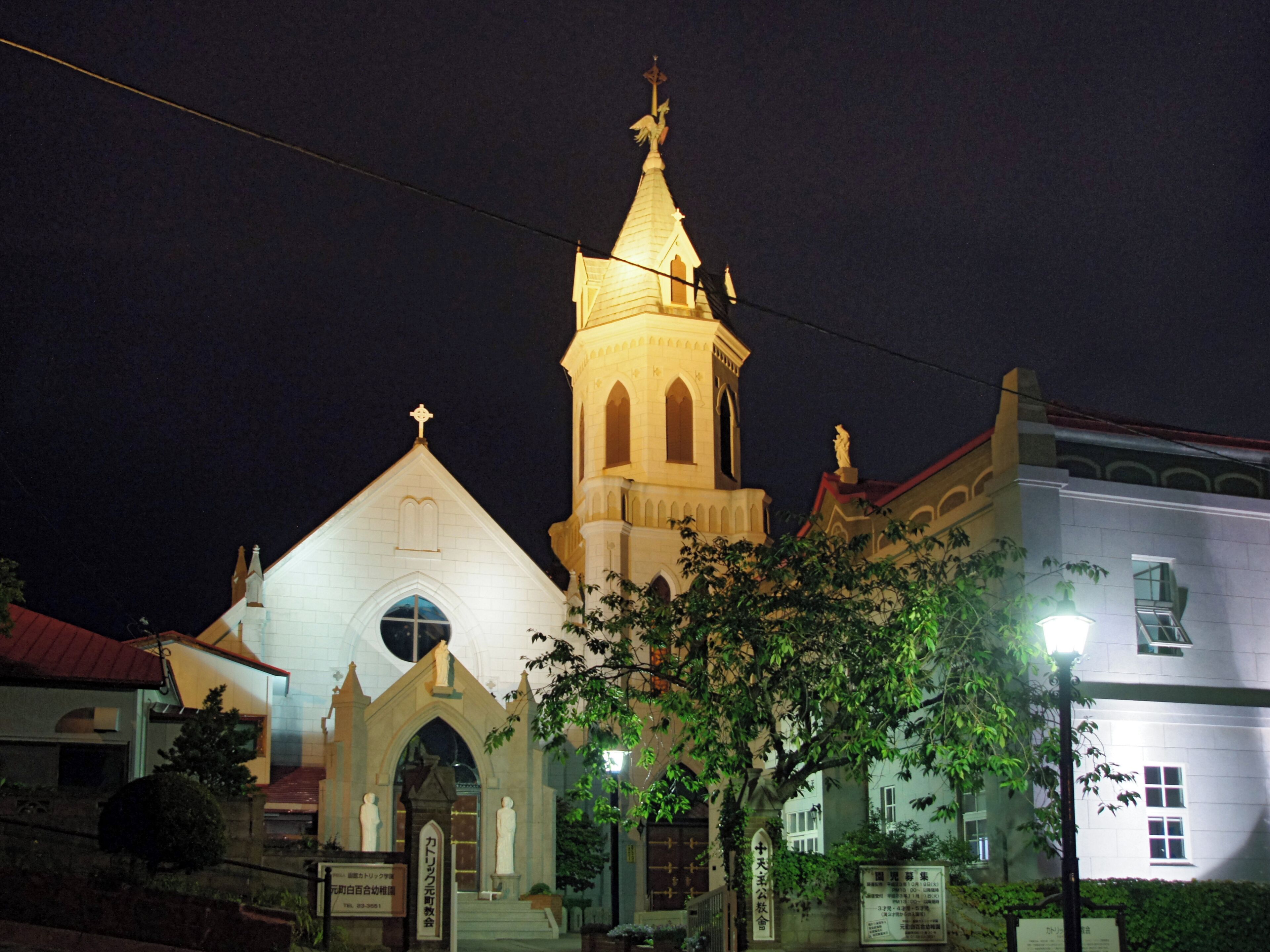 A church with a tall bell tower and a smaller adjacent building.