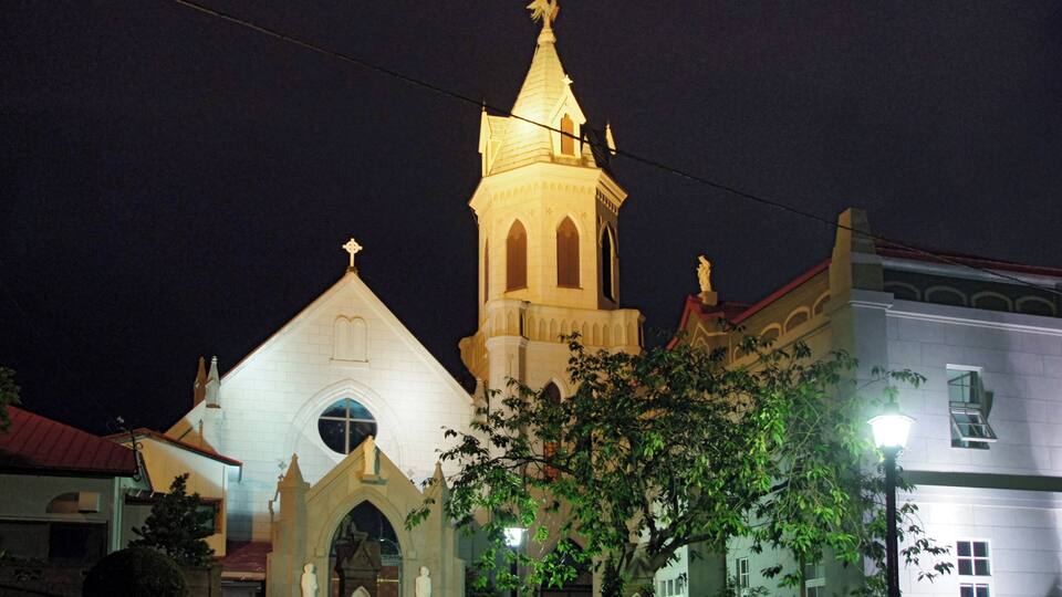 A church with a tall bell tower and a smaller adjacent building.