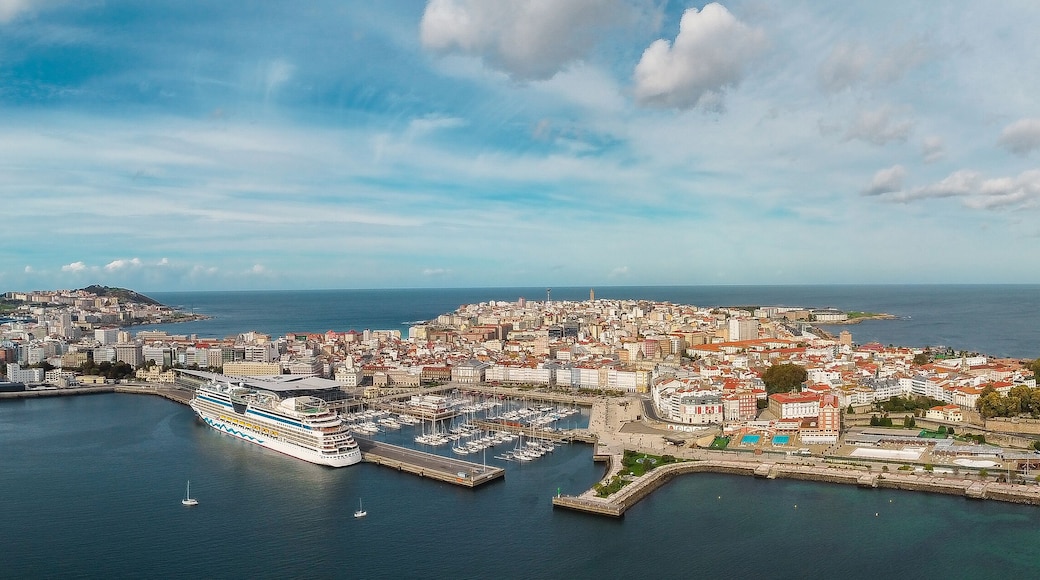 Panoramic aerial view of A Coruña City. View of Harbour and Old town center. Famous travel destination in Galicia, North-west of Spain. Large cruise ship doked in the port. Cloudy day.