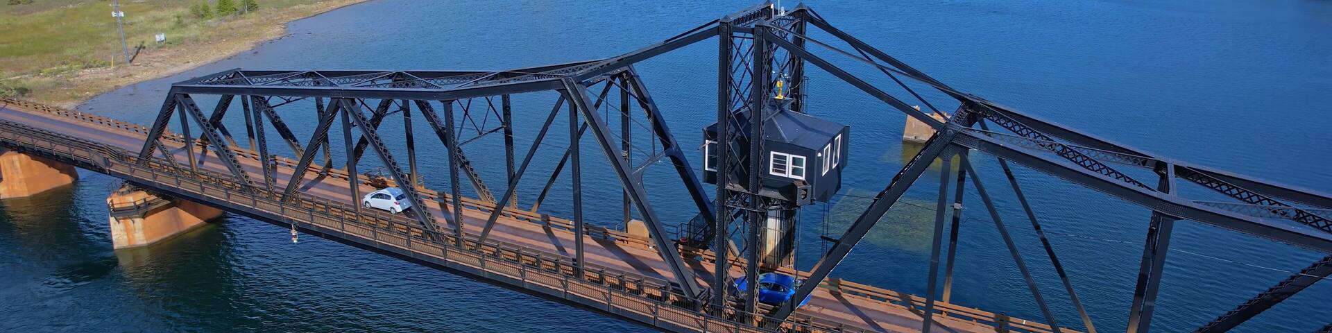 Aerial view of single lane traffic on Little Current Swing Bridge, Manitoulin Island. The bridge crosses North Channel on Highway 6. The historic bridge will be replaced with new two lane bridge.