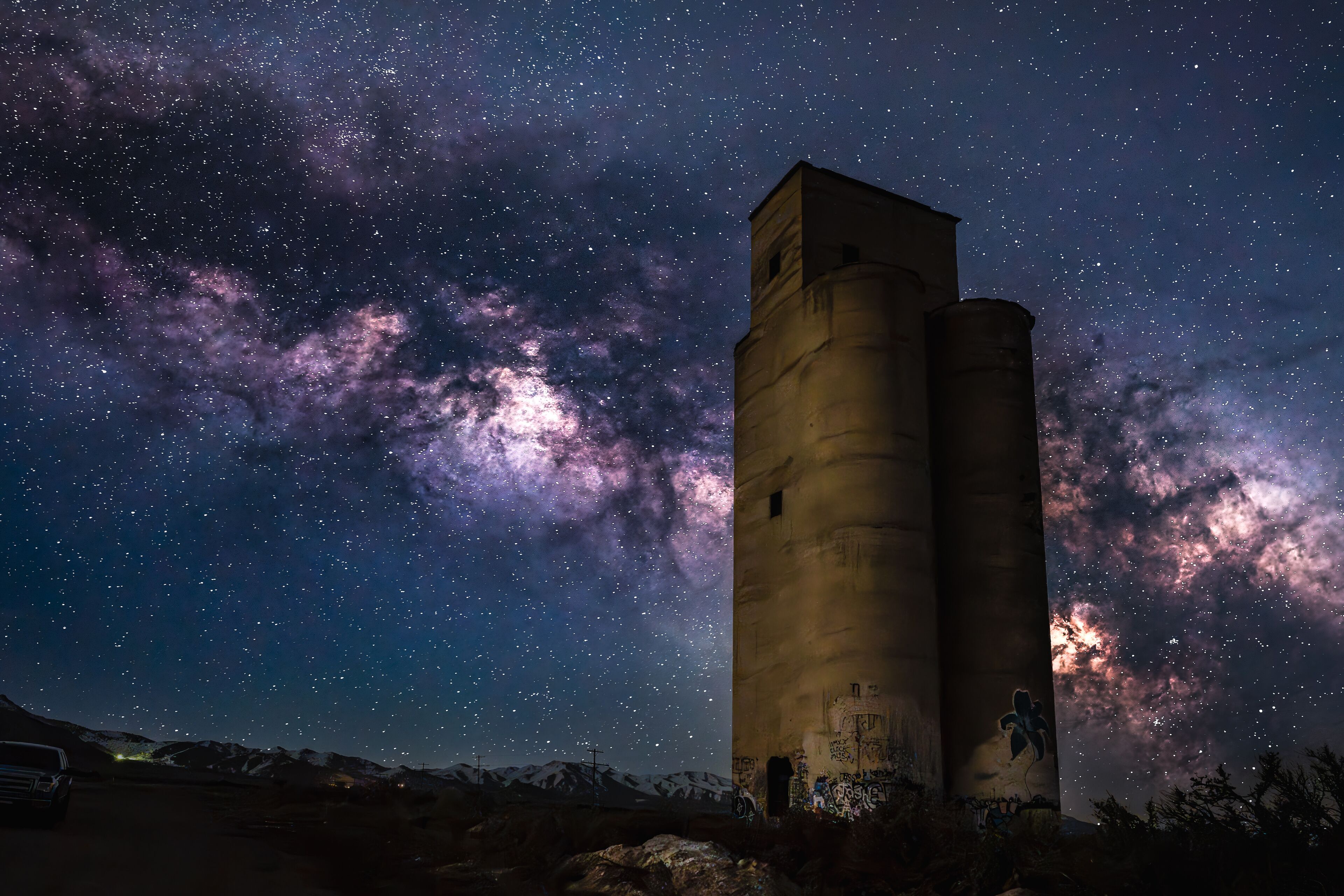 A tall tower under a starry night sky with the Milky Way visible.