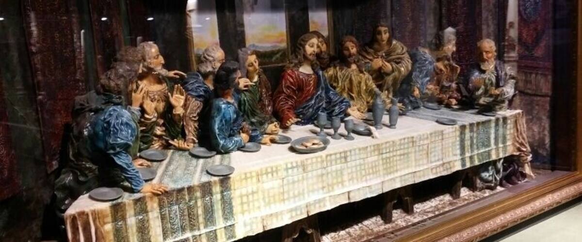 A detailed sculpture of the Last Supper with a table and figures.