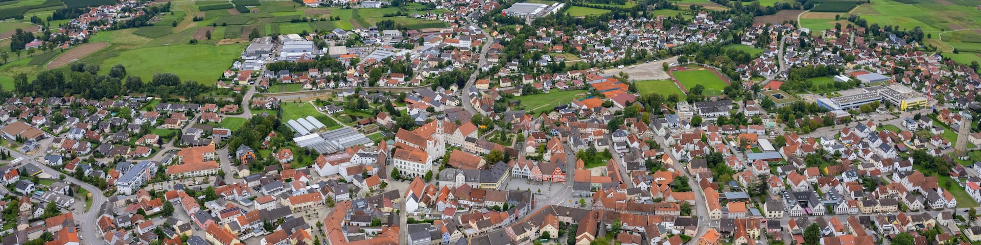 Aerial panoramic view around the old town of the city Geisenfeld, 85290 on a cloudy spring noon in Germany.