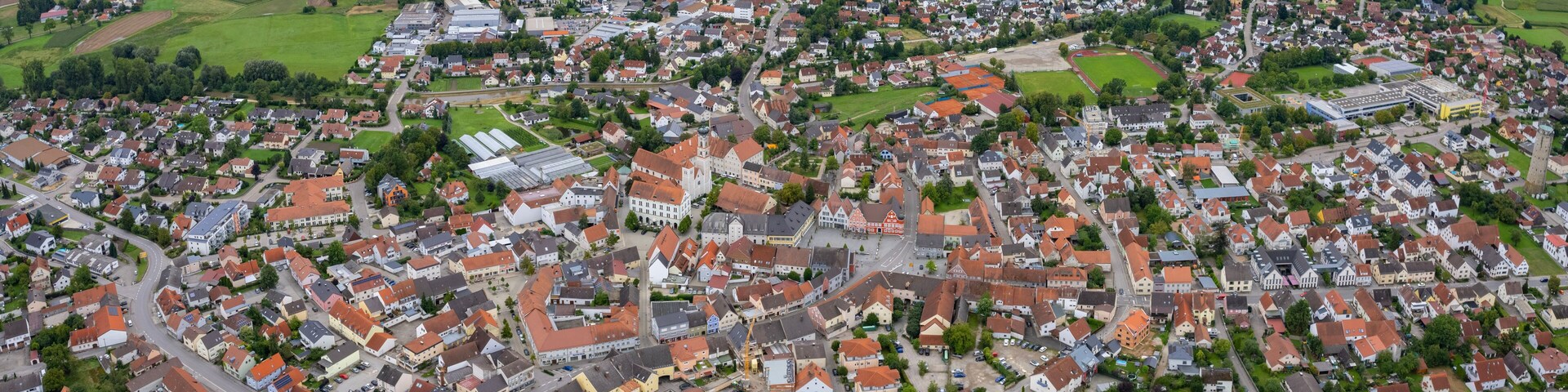 Aerial panoramic view around the old town of the city Geisenfeld, 85290 on a cloudy spring noon in Germany.
