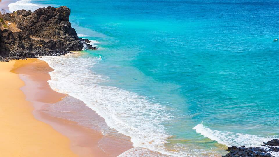 Incredible view of a shark swimming off the beach of Praia do Bode on the island of Fernando de Noronha, Brazil. A tourist surfing on this beach was recently bitten by a shark.