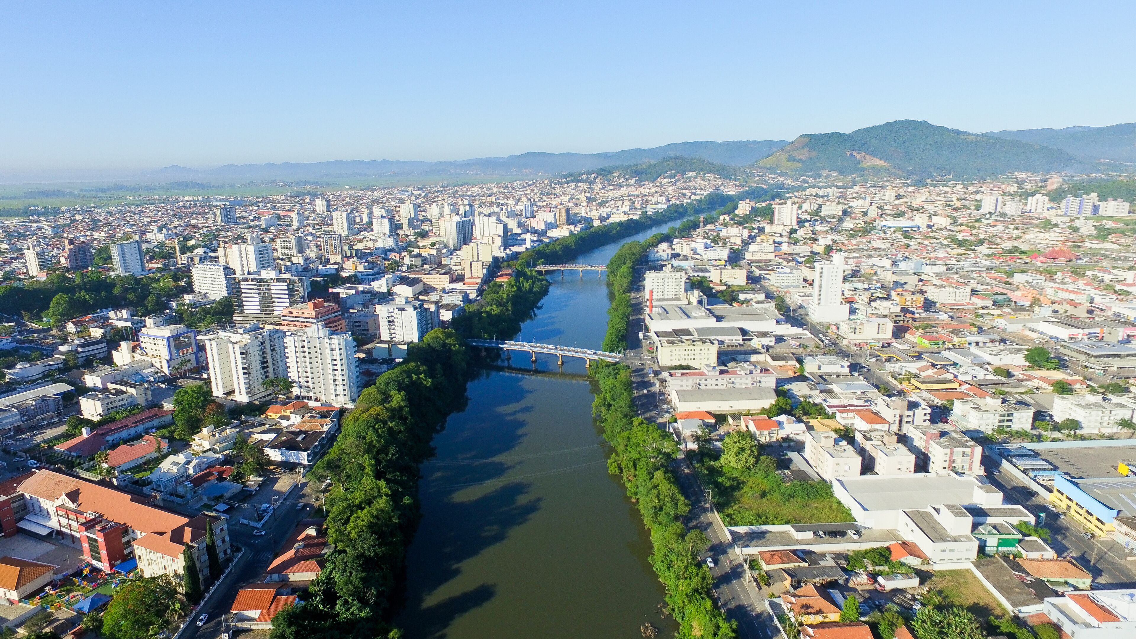 A river running through a city with a bridge and buildings on both sides.
