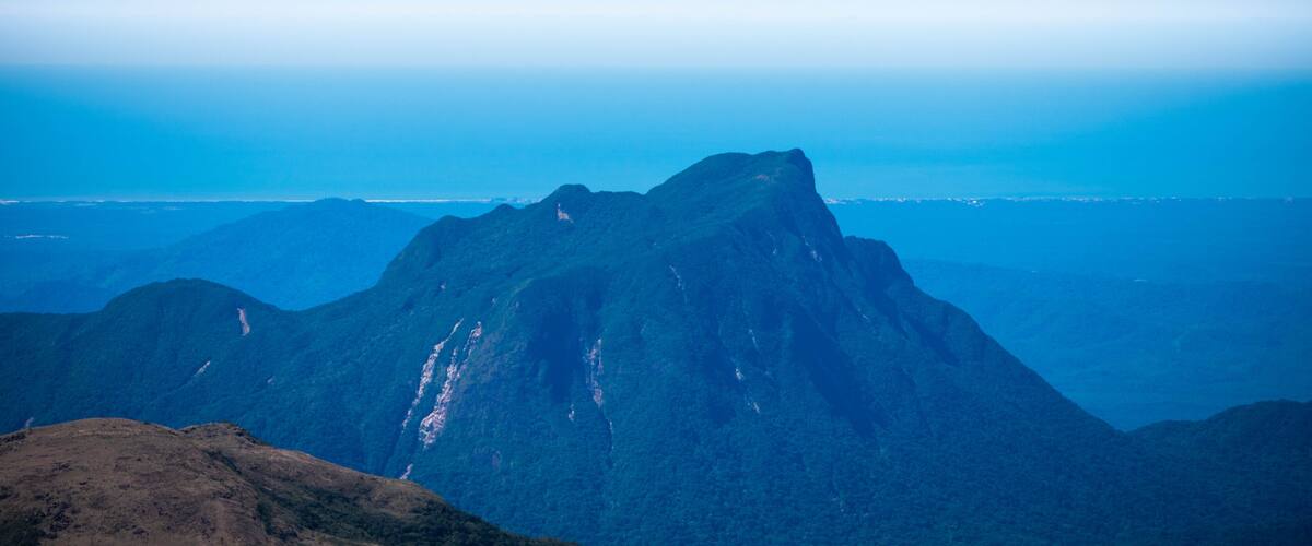 A mountain range with a prominent peak.