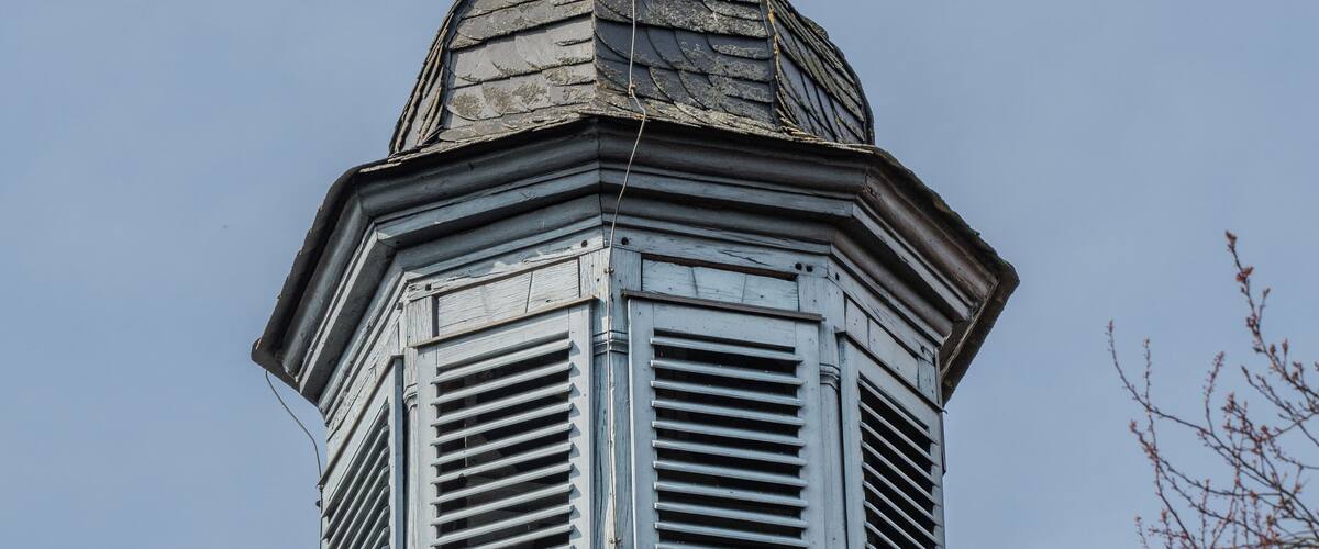 Roof ridge with tower clock at the branch church St. Wendelinus in Bramberg near Ebern
