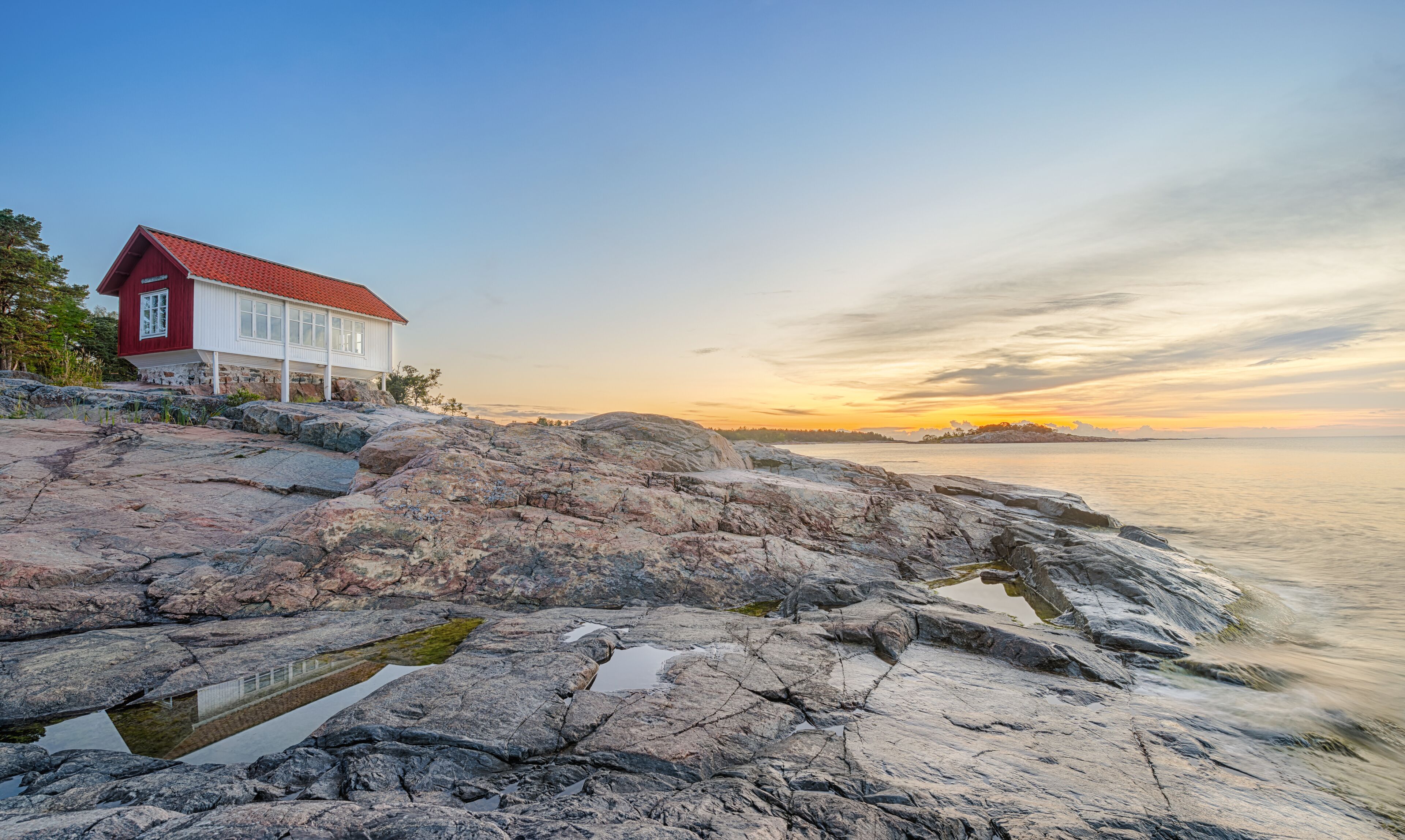 Red house at seafront in morning light