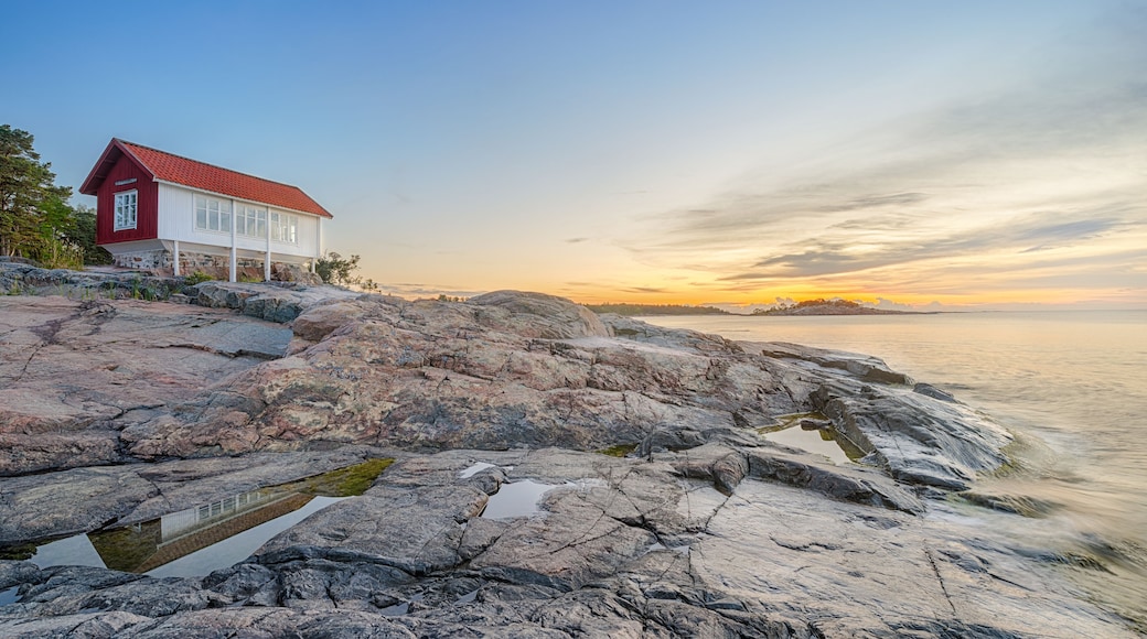 Red house at seafront in morning light