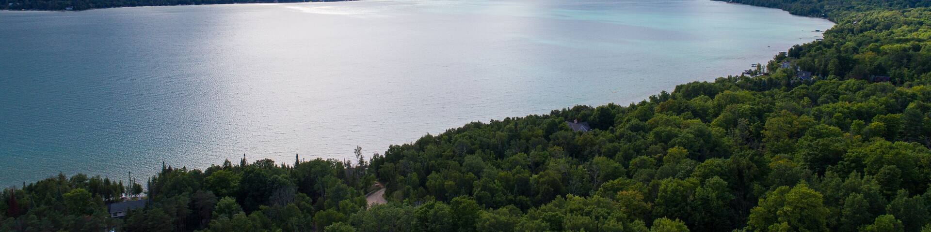 Aerial drone view of Torch Lake on overcast summer day.