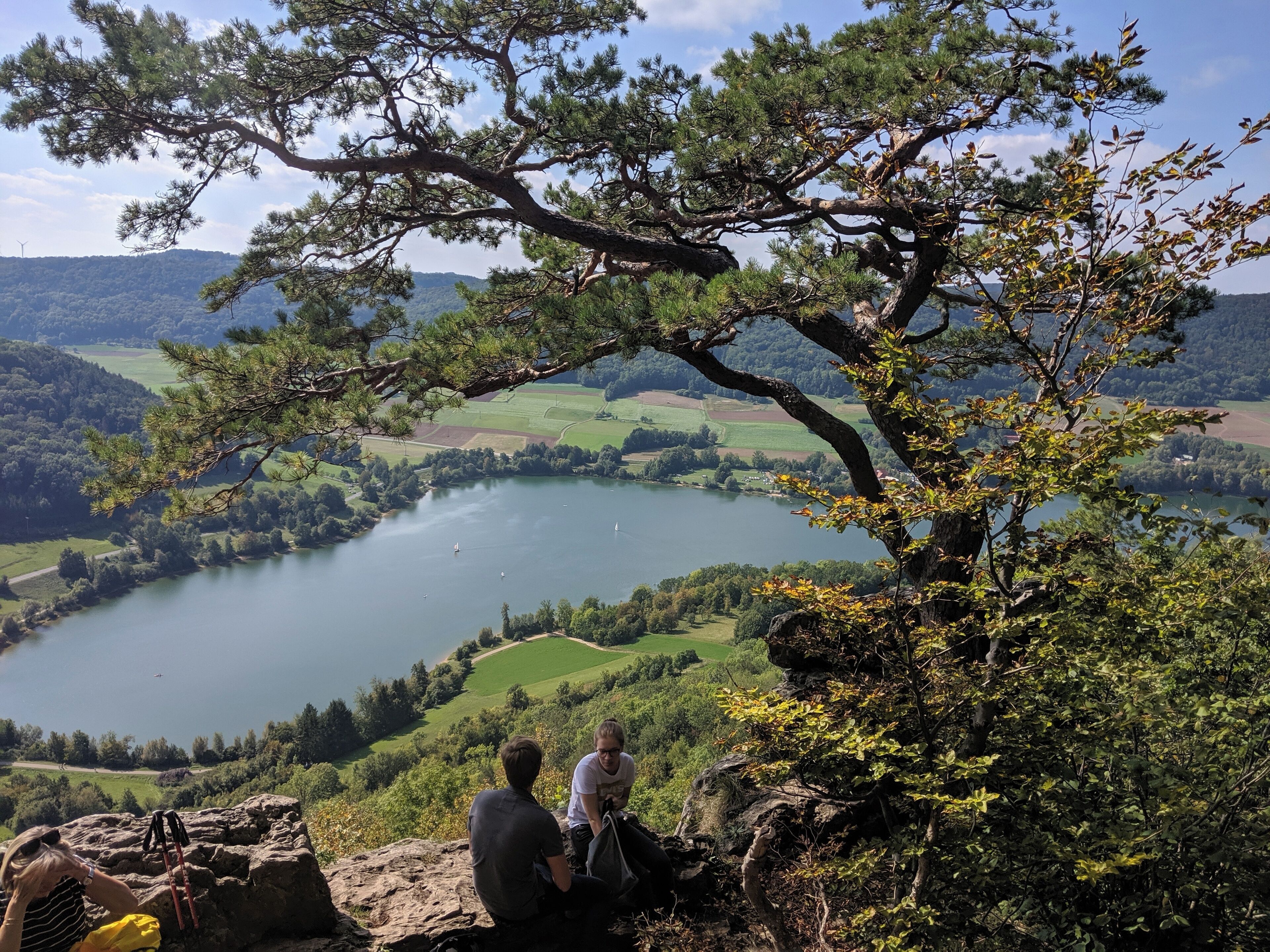 A lake surrounded by hills and trees.