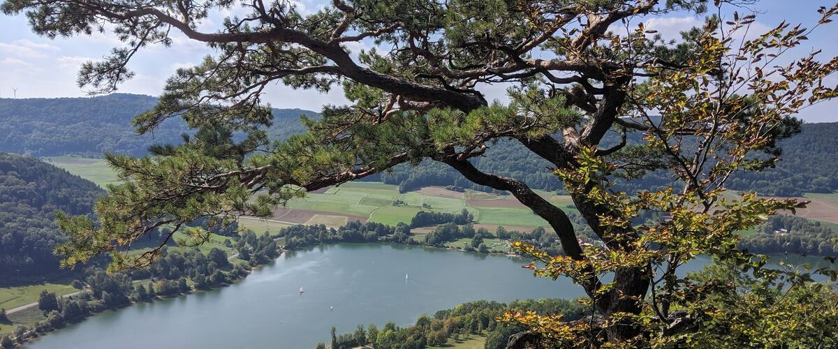 A lake surrounded by hills and trees.