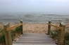 Beautiful midwest nature background. Landscape with wooden boardwalk to the beach through sand dunes and mist over the lake Michigan at Kohler-Andrae State Park, Sheboygan area, Wisconsin, USA.