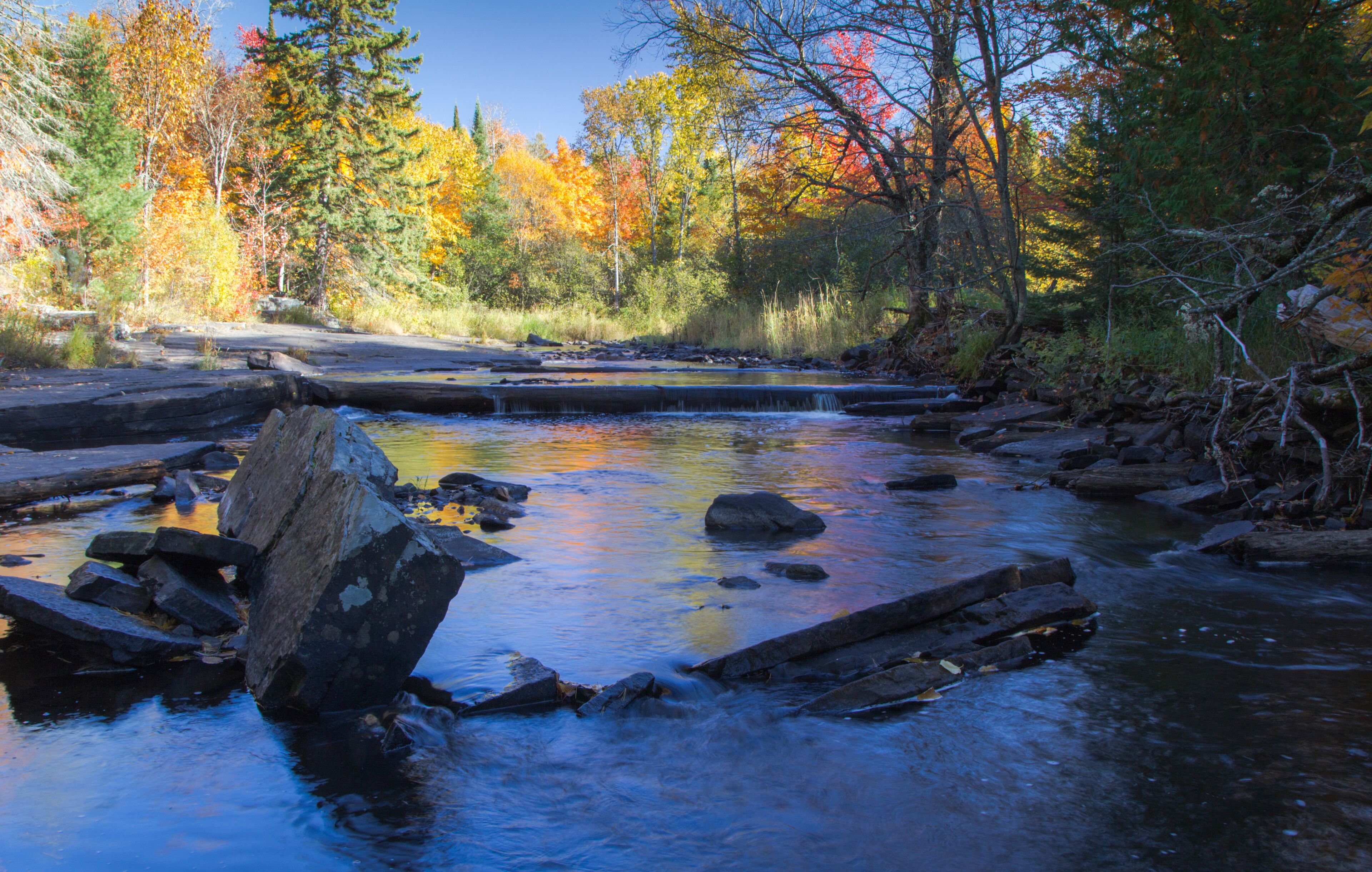 Autumn Forest River Landscape, Vibrant all foliage reflected in wilderness river at the Canyon Falls Scenic Site in the Upper Peninsula of Michigan.