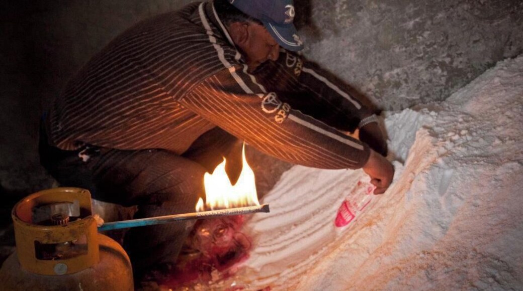 The only salt-making facilities using salt from the Salar de Uyuni are located in Colchani – a cooperative joint-owned by all salt workers. There is an estimated 10 billion tonnes of salt contained in the Salar de Uyuni, with around 25,000 tonnes excavated and processed at Colchani annually.
They scrape salt off the salar into pyramid-shaped piles and leave it to dry in the sun. Once dry (after 4 days or so) the salt is shoveled into trucks and carted to Colchani to be processed. It is cooked in ovens to dry further, then iodine is added and the mixture milled before being sealed into 1 kilogram sacks. The final product – table salt – is sold by the cooperative in Bolivia and Brazil.