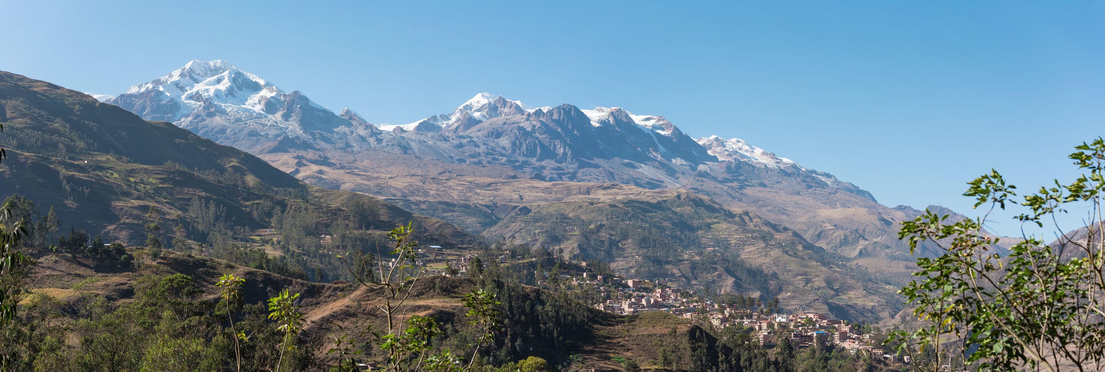 A mountainous landscape with a village nestled in the valley.