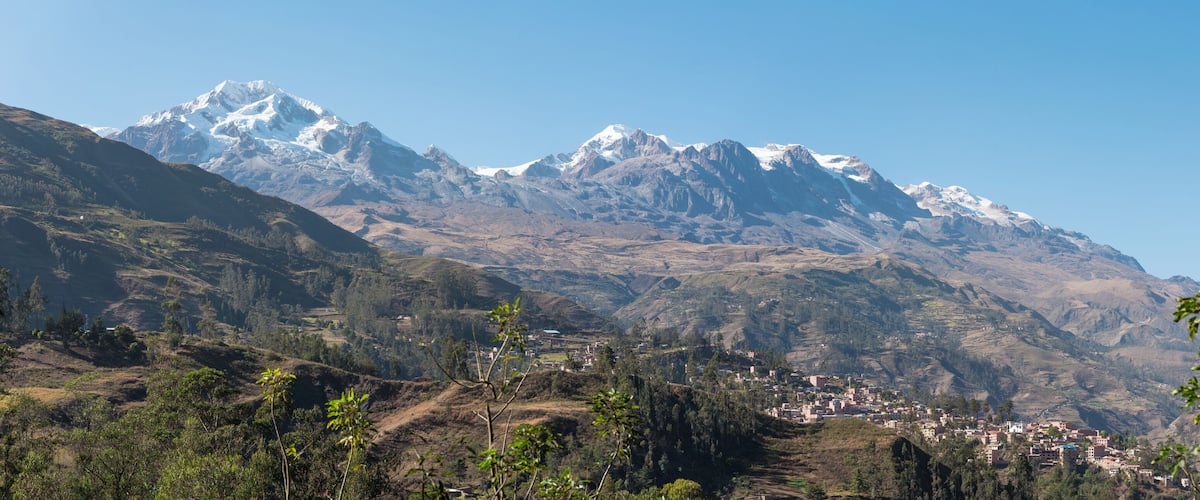 A mountainous landscape with a village nestled in the valley.
