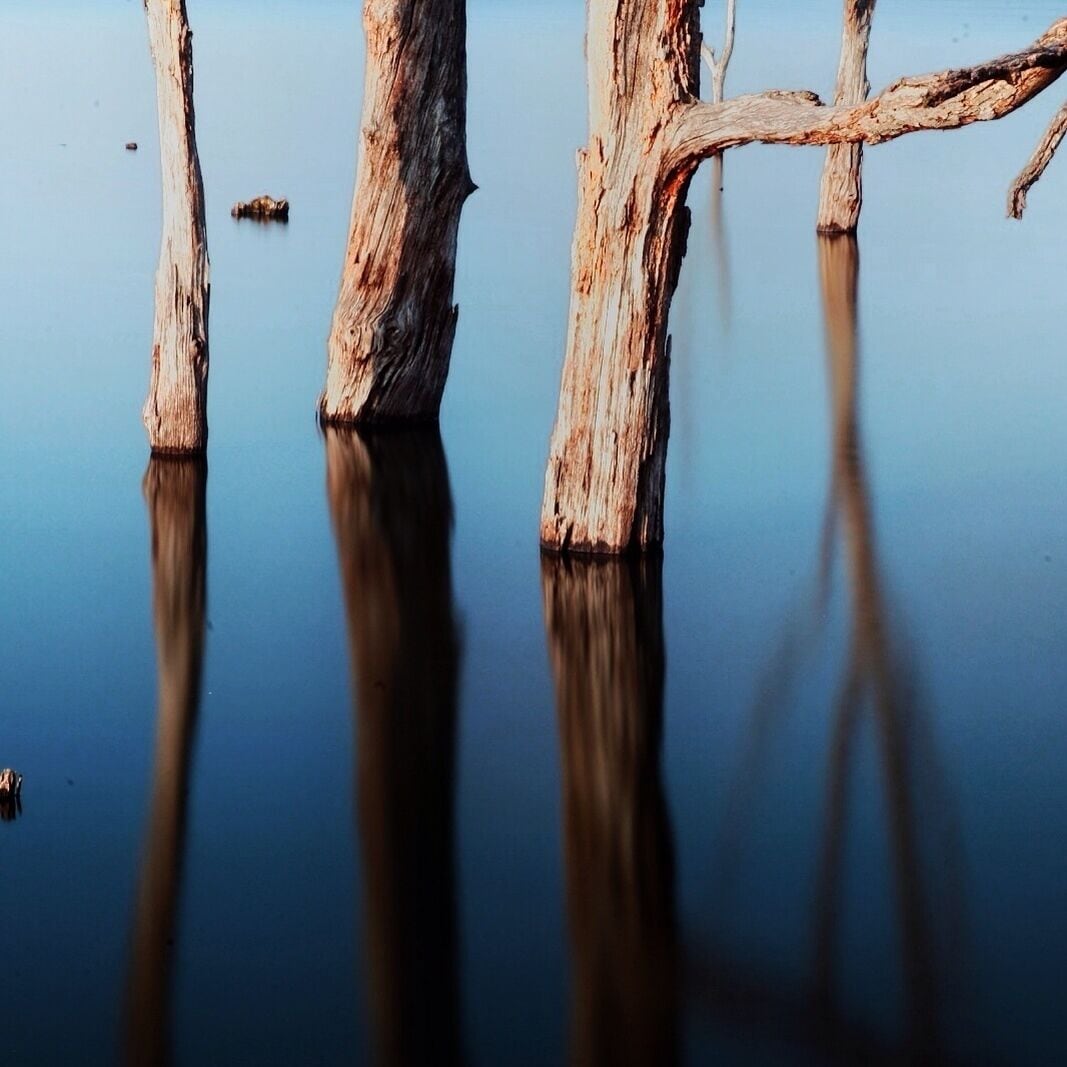 This is Lake Sugema. So, There I was. In Iowa, fir the second time in my life. Trying to find a place to camp. I wanted to camp on a small lake or river so I could fish. I planned on spending a couple days relaxing and fishing. First I headed into Iowa planning on staying at a campground about 70 miles west of here. but I forgot, some places don't open until Memorial Day, and that place was closed. So East I headed. I found this place as a fluke, Driving down Highway 2 there was just a small sign with a tent on it and left. Having no idea, I went left and found an absolutely amazing campground. it has about 7 tent sites, which is what we used, and about 20 full hookups. AND WARM WATER SHOWERS!!!!!! The water in the lake was still cold enough nothing was within casting distance from the shore, but during the summer this small lake boasts some of the best fishing in the state. More over, it is a man made lake and as such there are trees out into the lake. So after hiking around the area I went to taking some photos. These two shots are the same. black and white and color. They are about 2 minute exposures to even out the water. Tell me what you think. 


Like B/W or color?