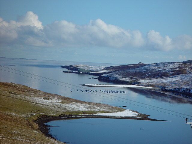Muckle Ayre, Dales Voe, Shetland. Looking north east along Dales Voe over mussel rafts to Muckle Ayre. Further to the north east is the rig repair/decommissioning base at Dales Voe.