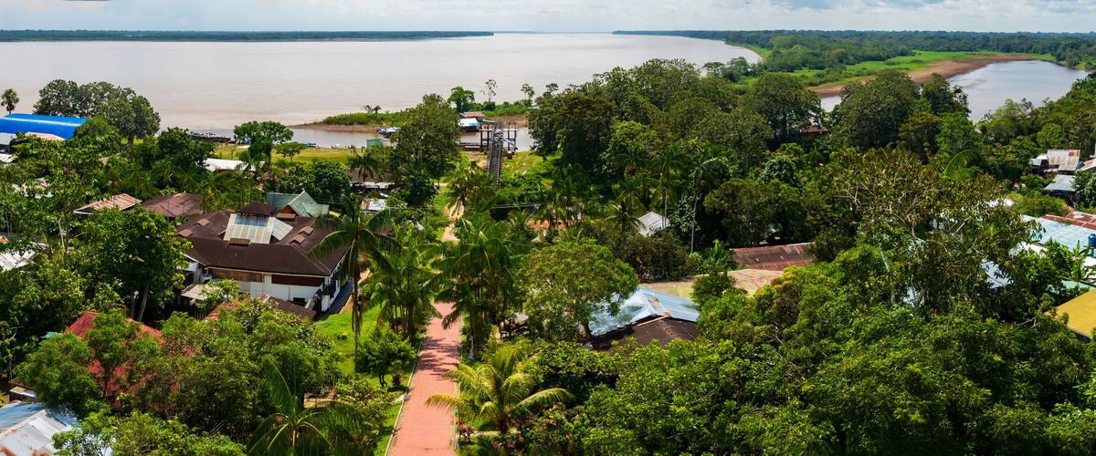 A river with houses and trees along its banks.