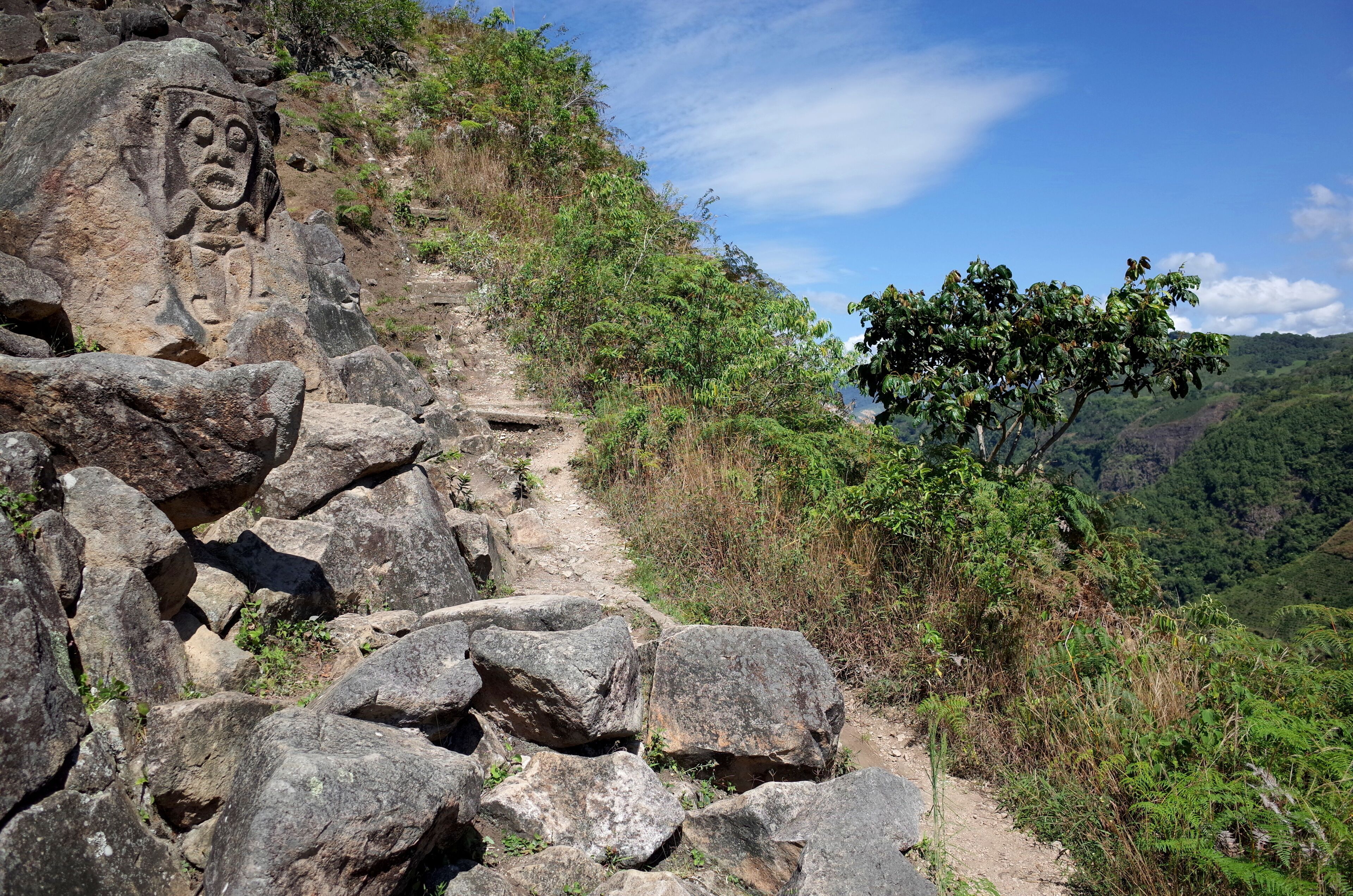 An ancient rock carving looks out over the valley near San Agustin archaeological park Colombia