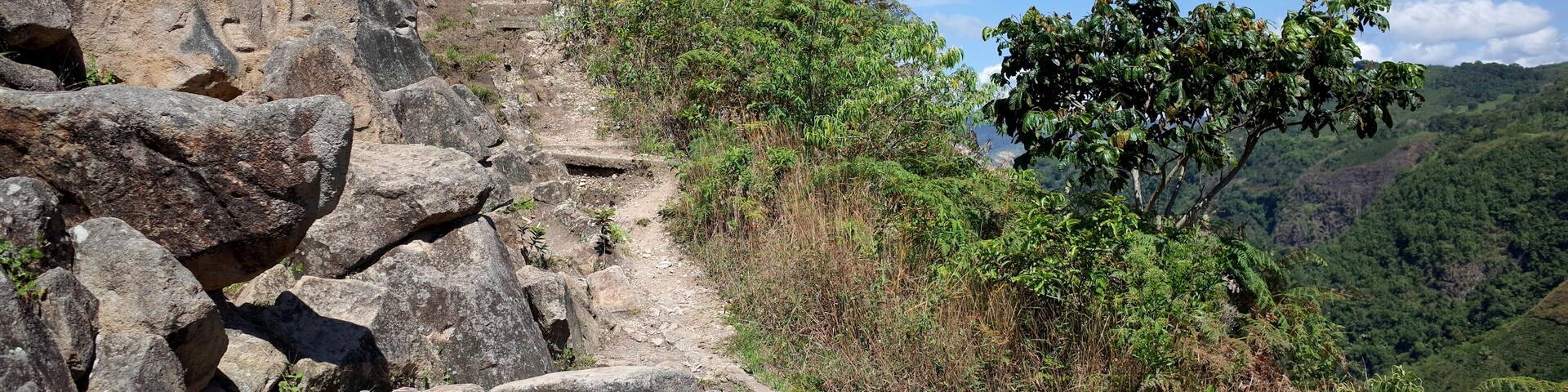 An ancient rock carving looks out over the valley near San Agustin archaeological park Colombia