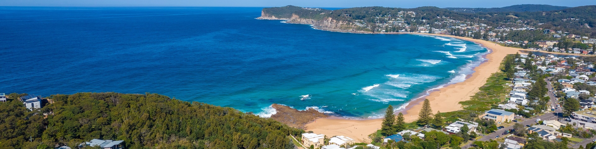 Blue ocean with large waves crashing on to North Avoca Shoreline in New South Wales Australia