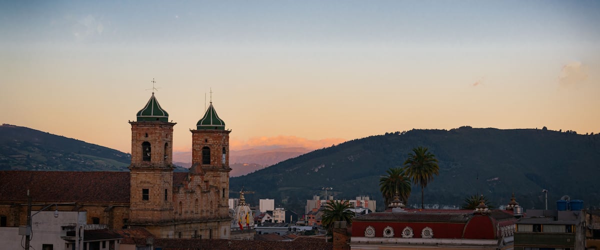 A church with two towers and a moon in the sky.