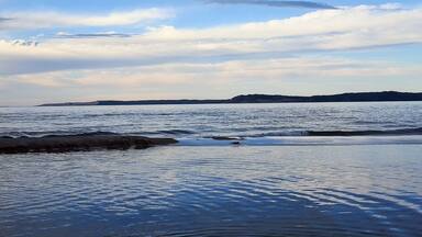 Dusk looking over the Platte River and lake Michigan to the Sleeping Bear Sand Dunes on the horizon.