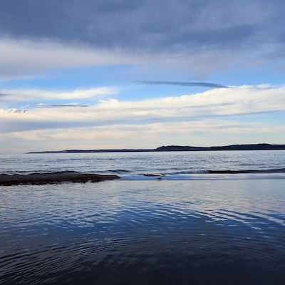 Dusk looking over the Platte River and lake Michigan to the Sleeping Bear Sand Dunes on the horizon.