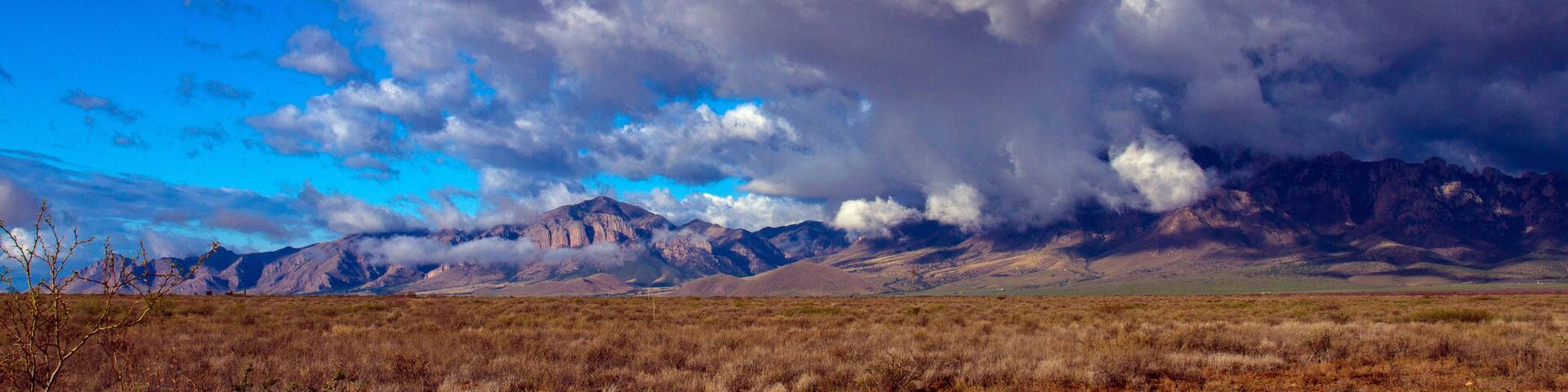 Arizona's Chiricahua Mountains under a large storm cloud