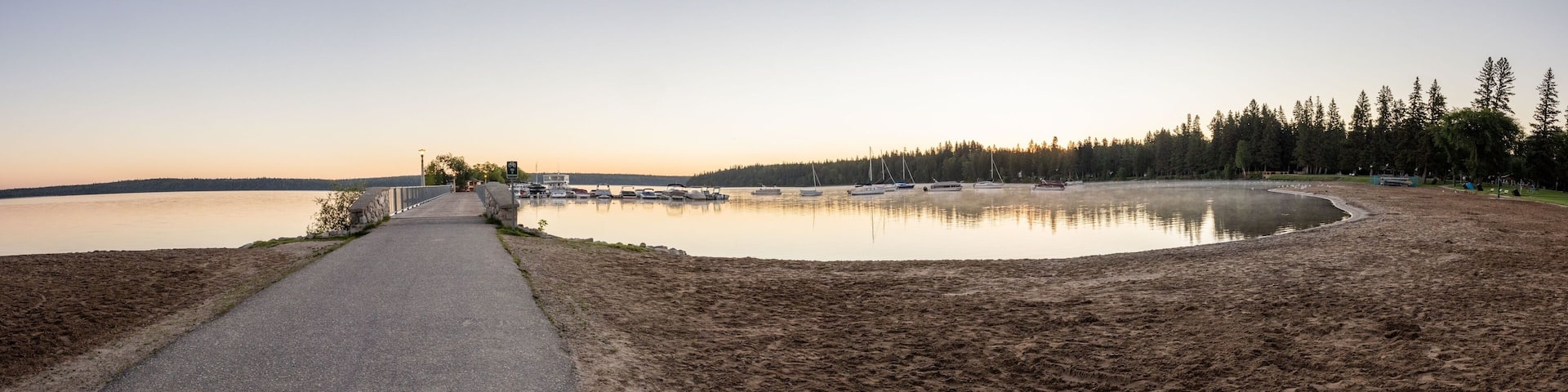 Panoramic view of a pier and beach at Clear Lake in Riding Mountain National Park